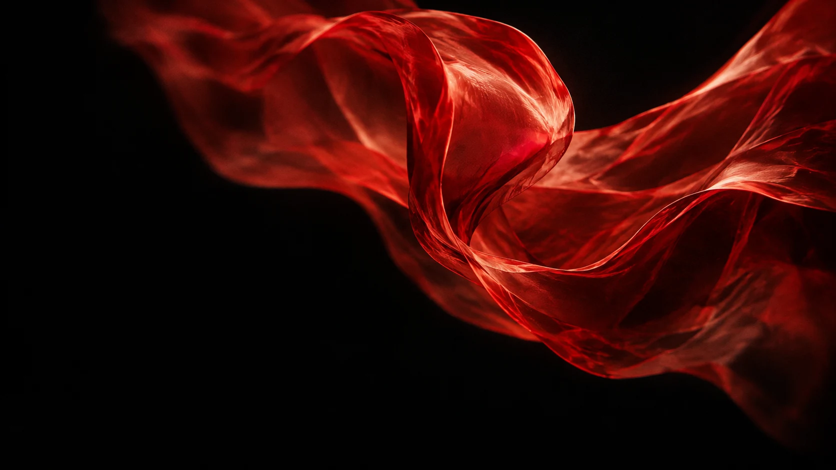 Translucent scarlet ribbon caught in motion against a black background